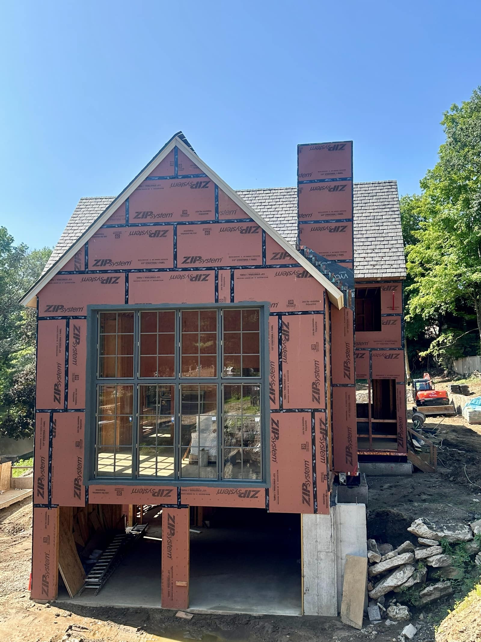 Gable elevation - steel-look grid window carried up under the ridge.